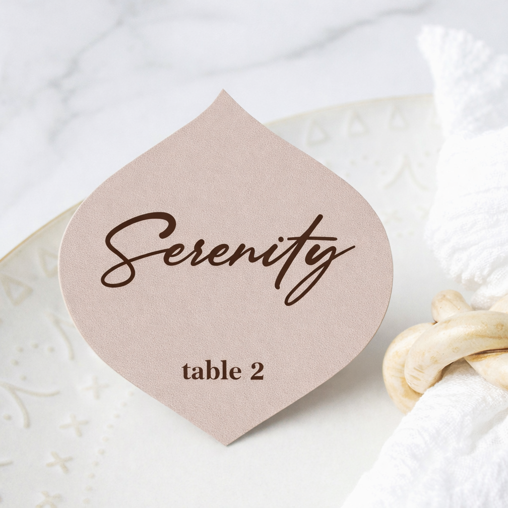 Place card with 'Serenity' and 'table 2' on a textured surface