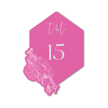 Hexagonal pink table number card with floral design and white ink print.