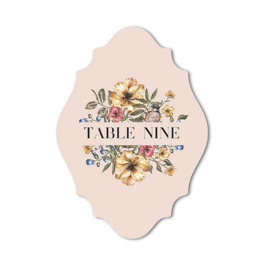 Custom shaped table number card with floral design on a beige background