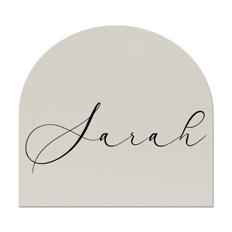Arch-shaped wedding place card with 'Sarah' written in cursive on a white background