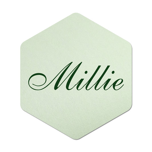 Hexagonal light green place card with 'Millie' in green text on a white background
