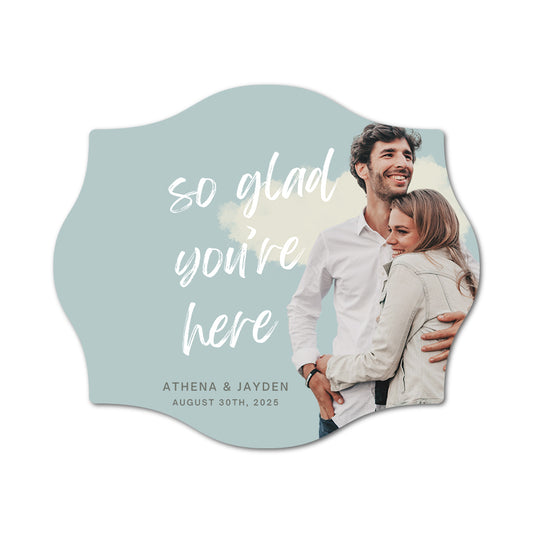 Personalized custom print favor label with a couple and text 'so glad you're here' on a light blue background.