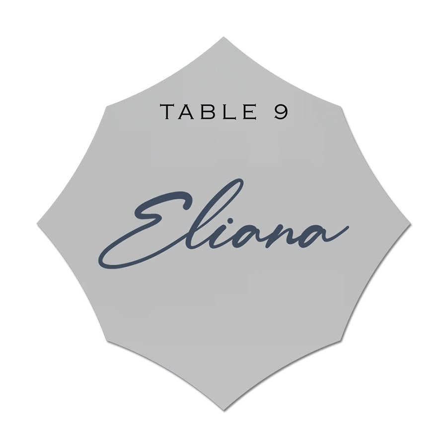 Hexagonal name card with 'Eliana' and 'Table 9' text on a light gray background
