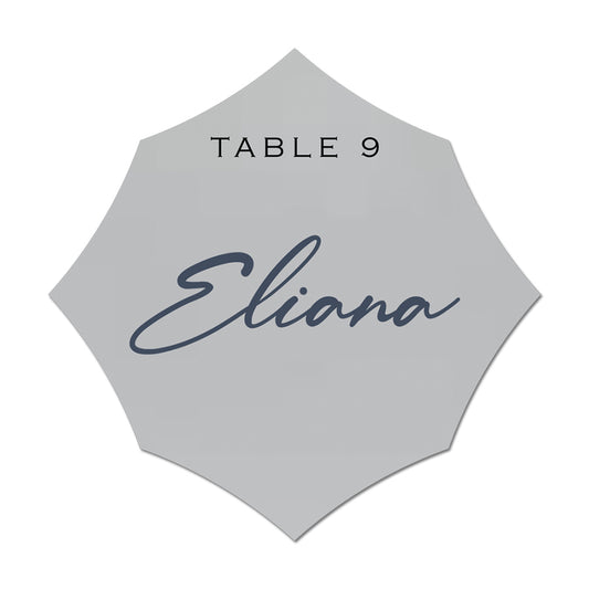 Hexagonal name card with 'Eliana' and 'Table 9' text on a light gray background