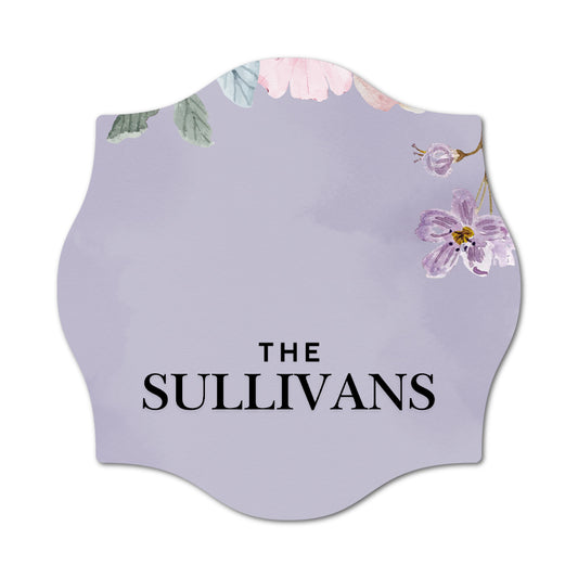 Decorative sign with floral design and 'The Sullivans' text on a light purple background
