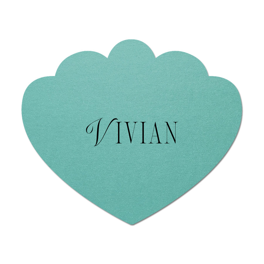 Teal scallop-shaped card with 'Vivian' printed on it against a white background