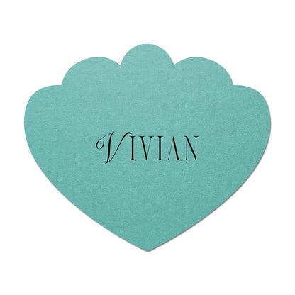 Teal scallop-shaped card with 'Vivian' printed on it against a white background