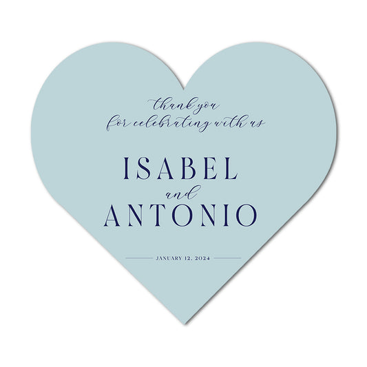 Heart-shaped light blue thank you tags
with text 'thank you for celebrating with us ISABEL and ANTONIO JANUARY 12, 2024' on a white background.