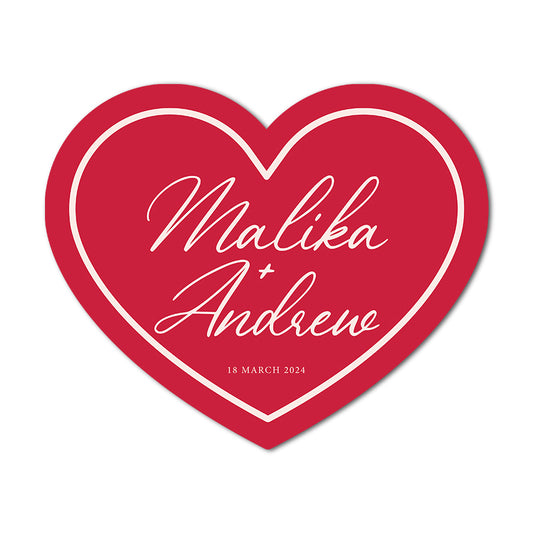 Red heart-shaped wedding tags with 'Malika + Andrew' and a date on a white background